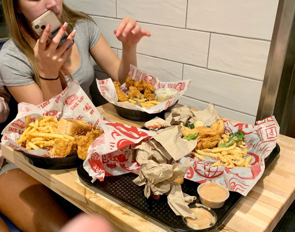 The signature meal for Raising Caine's is a simple one - chicken fingers, french fries and cole slaw along with Cane's Sauce.