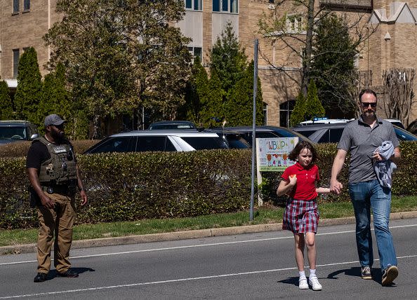 NASHVILLE, TN - MARCH 27:  A parent walks with their child from Woodmont Baptist Church where children were reunited with their families after a mass shooting at The Covenant School on March 27, 2023 in Nashville, Tennessee. According to initial reports, three students and three adults were killed by the shooter, a 28-year-old woman. The shooter was killed by police responding to the scene. (Photo by Seth Herald/Getty Images)