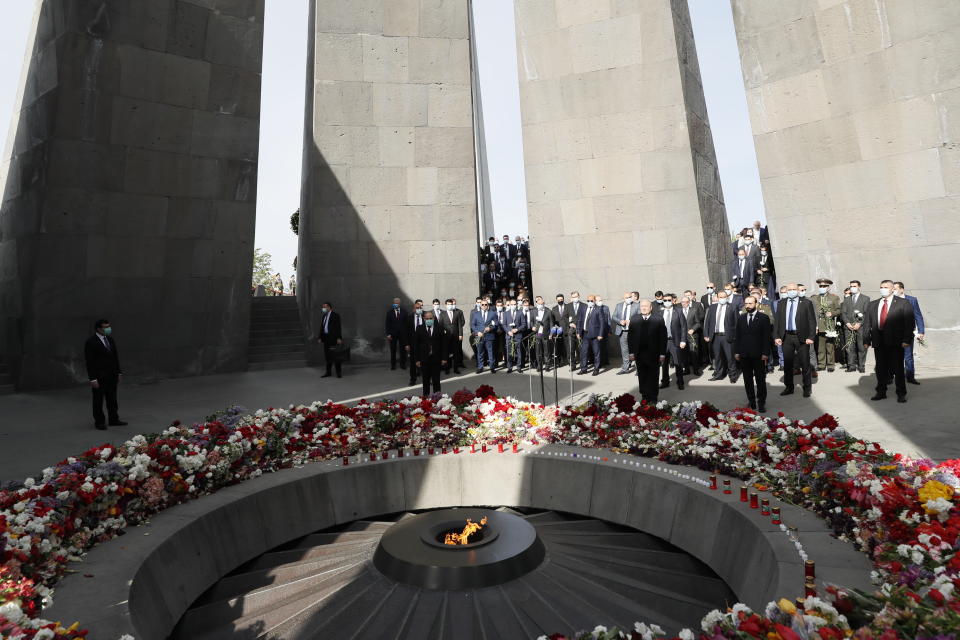 Armenian Prime Minister Nikol Pashinyan, center, attends a memorial service at the monument to the victims of mass killings by Ottoman Turks, to commemorate the 106th anniversary of the massacre, in Yerevan, Armenia, Saturday, April 24, 2021. Armenians marked the anniversary of the death of up to 1.5 million Armenians by Ottoman Turks, an event widely viewed by scholars as genocide, though Turkey refutes the claim. (Tigran Mehrabyan/PAN Photo via AP)