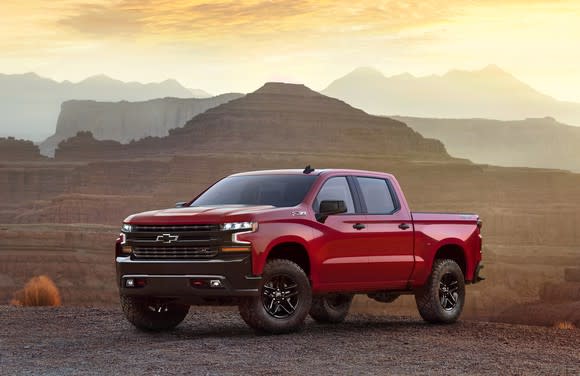 A red 2019 Chevrolet Silverado pickup truck in a desert setting.