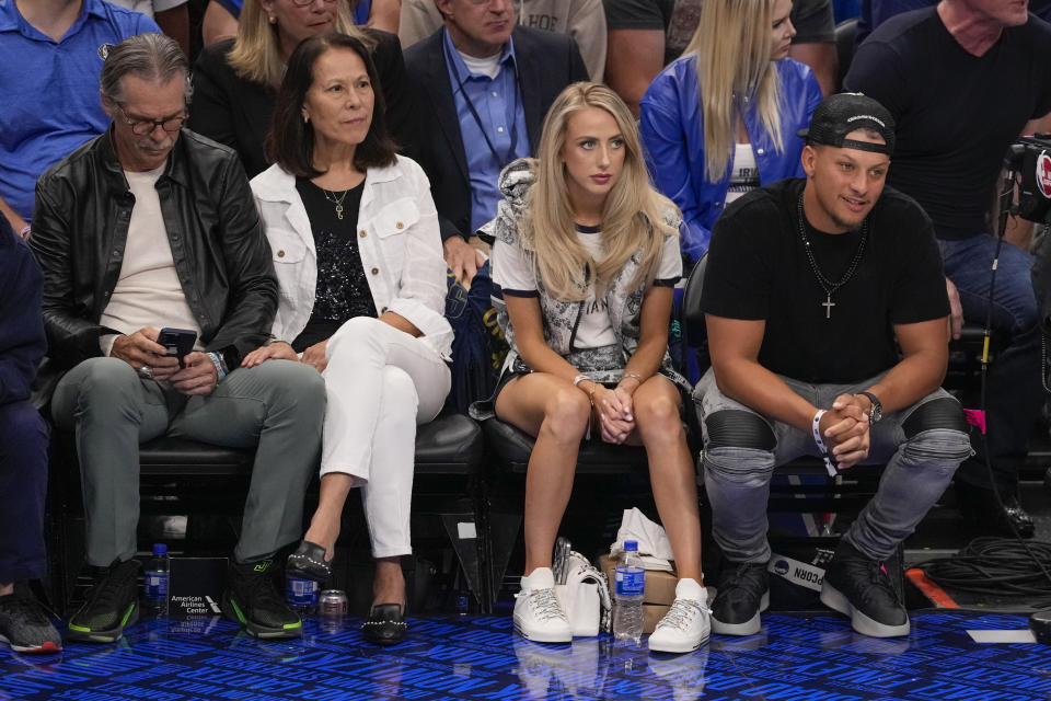 NFL football quarterback Patrick Mahomes, right, of the Kansas City Chiefs, sits courtside with his wife Brittany Mahomes during the second half in Game 3 of the NBA basketball finals between the Dallas Mavericks and the Boston Celtics, Wednesday, June 12, 2024, in Dallas. (AP Photo/Sam Hodde)