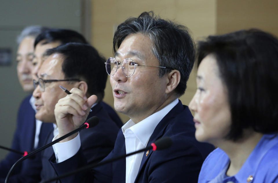 Sung Yun-mo, second from right, South Korea's minister of Trade, Industry and Energy, speaks during a press conference at the government complex in Seoul, South Korea, Monday, Aug. 5, 2019. Sung said South Korea will spend 7.8 trillion won ($6.5 billion) over the next seven years to develop technologies for industrial materials and parts as it moves to reduce its dependence on Japan during an escalating trade row. The announcement came days after Japan's Cabinet approved the removal of South Korea from a list of countries with preferential trade status. (AP Photo/Ahn Young-joon)