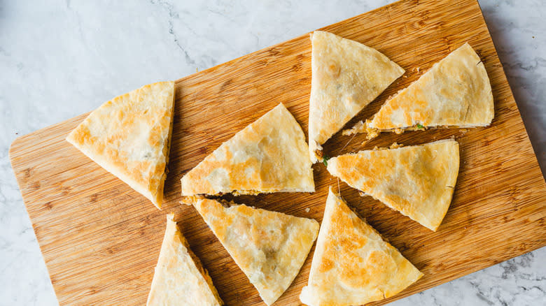 Slices of quesadilla on a cutting board