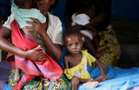 <p>An internally displaced woman sits with her severely acute malnourished children as they wait to receive medical attention at the Tshiamala general referral hospital of Mwene Ditu in Kasai Oriental Province in the Democratic Republic of Congo, March 15, 2018. (Photo: Thomas Mukoya/Reuters) </p>