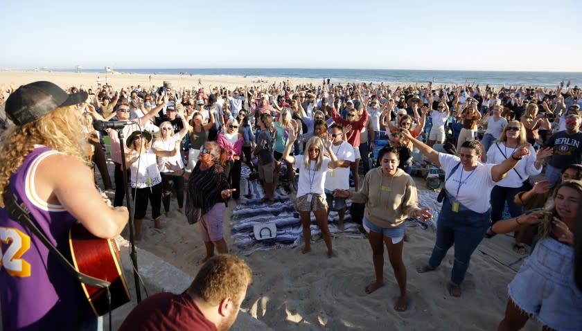 Hundreds gathered for the weekly Saturate OC worship event held north of the pier in Huntington Beach, on Friday, July 10, 2020.