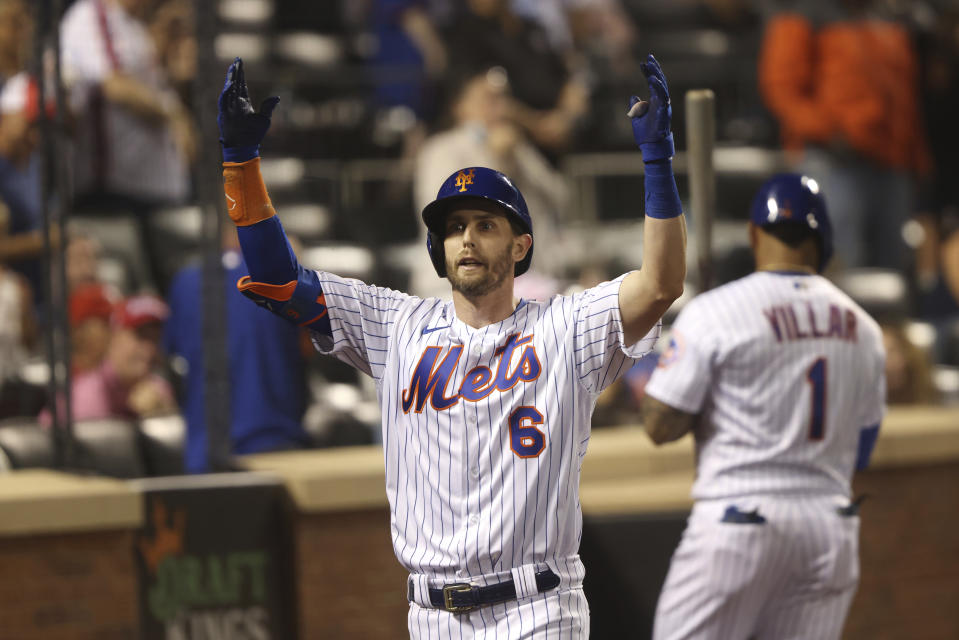 New York Mets' Jeff McNeil celebrates as he returns to the dugout after hitting a home run during the seventh inning of a baseball game against the Philadelphia Phillies, Sunday, Sept. 19, 2021, in New York. (AP Photo/Jason DeCrow)