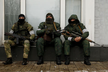 Armed men wearing masks are seen in the centre of rebel-controlled city of Luhansk, Ukraine November 22, 2017. REUTERS/Alexander Ermochenko