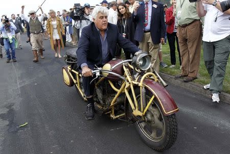 TV personality Jay Leno rides a 1930 Bohmerland motorcycle around the grounds during the Concours d'Elegance at the Pebble Beach Golf Links in Pebble Beach, California, August 17, 2014. REUTERS/Michael Fiala