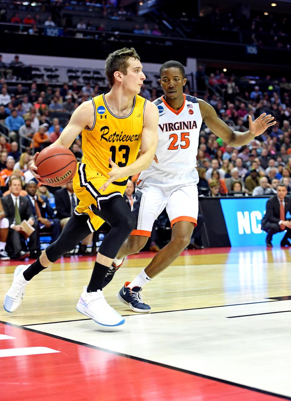 Mar 16, 2018; Charlotte, NC, USA; UMBC Retrievers forward Joe Sherburne (13) drives to the basket against Virginia Cavaliers forward Mamadi Diakite (25) during the first half in the first round of the 2018 NCAA Tournament at Spectrum Center. Mandatory Credit: Bob Donnan-USA TODAY Sports