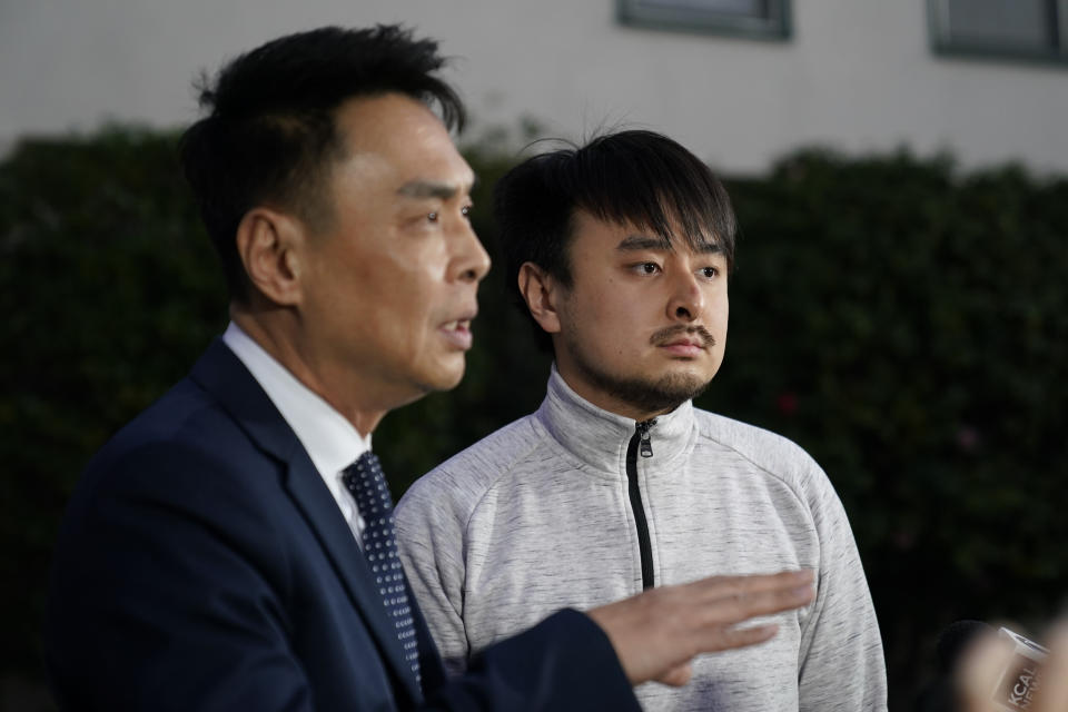 Brandon Tsay, 26, right, and his father, Tom Tsay, make a statement outside their home on Monday, Jan. 23, 2023, in San Marino, Calif. Brandon Tsay disarmed a gunman who killed multiple people late Saturday amid Lunar New Years celebrations in the predominantly Asian American community of Monterey Park. The gunman started at the Star Ballroom Dance Studio in Monterey Park and continued to Lai Lai Ballroom and Studio in Alhambra, where he was disarmed by Tsay. (AP Photo/Ashley Landis)