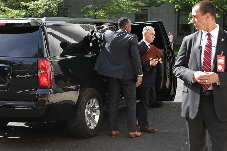 Surrounded by security agents, Environmental Protection Agency Administrator Scott Pruitt (2nd R) steps out of his armored SUV as he arrives to testify before the House Energy and Commerce Committee's Environment Subcommittee outside the Rayburn House Office Building on Capitol Hill April 26, 2018 in Washington, DC. The focus of nearly a dozen federal inquiries into his travel expenses, security practices and other issues, Pruitt testified about his agency's FY2019 budget proposal.