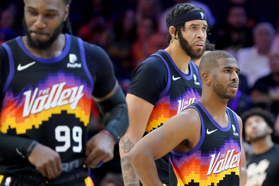 Phoenix Suns guard Chris Paul, right, forward Jae Crowder (99) and center JaVale McGee react to a call during the second half of Game 7 of an NBA basketball Western Conference playoff semifinal against the Dallas Mavericks, Sunday, May 15, 2022, in Phoenix. The Mavericks defeated the Suns 123-90. (AP Photo/Matt York)