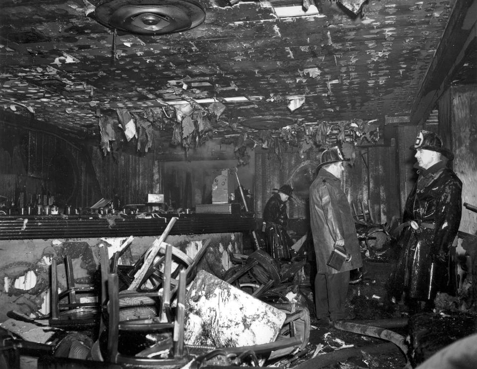 FILE - In this Nov. 28, 1942 file photo, firemen inspect the ruins of the Cocoanut Grove nightclub in Boston, where 492 people died in a fire. A 2019 documentary film, "Six Locked Doors: The Legacy of Cocoanut Grove," tells the story of the disaster that led to an overhaul and stricter enforcement of building safety codes. (AP Photo, File)