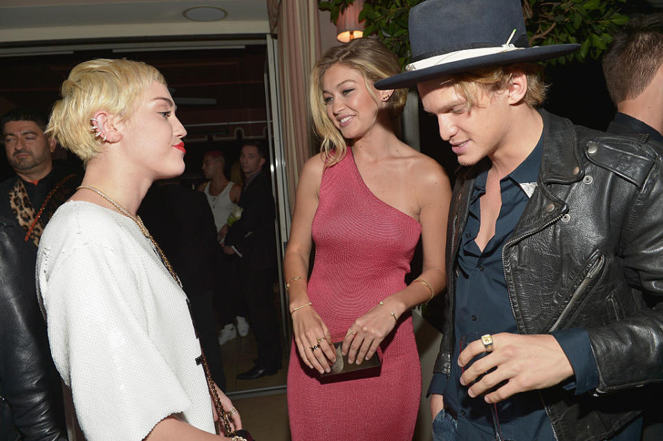 Miley Cyrus, left, talks to model Gigi Hadid and Cody Simpson at the Fashion Los Angeles Awards Show at Sunset Tower on Jan. 22, 2015, in West Hollywood, Calif. (Photo by Charley Gallay/Getty Images for the DAILY FRONT ROW) 