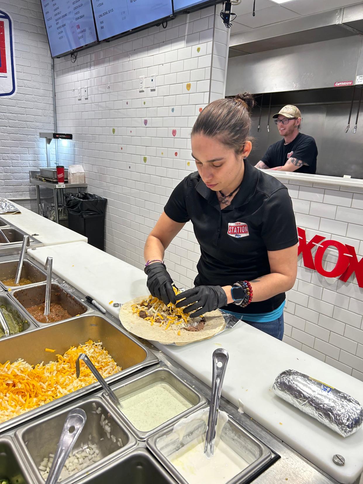 Anna Rivers finishes a custom made burrito for a hungry customer at Cowboy Station in the Conoco Station off McCormick Road. Rivers makes her own chili and keeps the recipe secret.