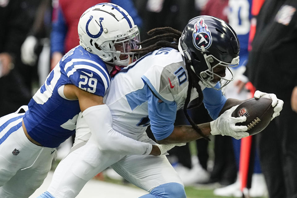 Indianapolis Colts cornerback JuJu Brents (29) tackles Tennessee Titans wide receiver DeAndre Hopkins (10) after a catch during the second half of an NFL football game, Sunday, Oct. 8, 2023, in Indianapolis. (AP Photo/Darron Cummings)