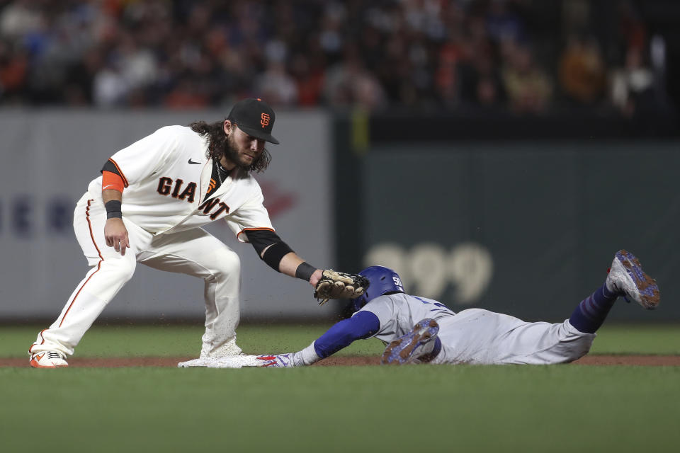 Los Angeles Dodgers' Mookie Betts, bottom, steals second base against San Francisco Giants shortstop Brandon Crawford during the sixth inning of Game 5 of a baseball National League Division Series Thursday, Oct. 14, 2021, in San Francisco. (AP Photo/Jed Jacobsohn)