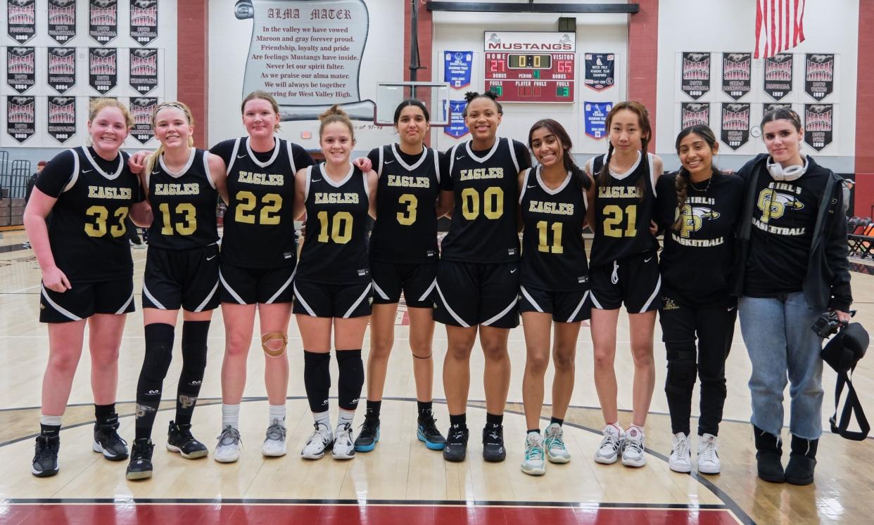 The Oak Park High girls basketball team poses for a photo after the Eagles defeated West Valley 65-27 in Hemet on Saturday night to reach the CIF-Southern Section Division 5A championship game.