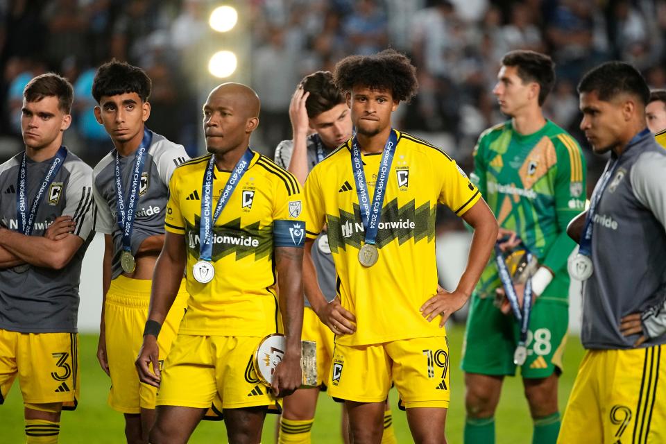 Crew players watch as Pachuca receives the trophy following the Champions Cup on Saturday.