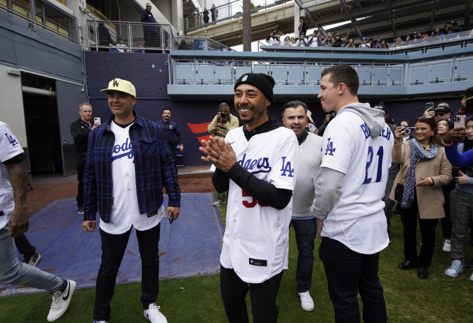 Los Angeles Dodgers' Mookie Betts, center, arrives with teammates for DodgerFest at Dodger Stadium, Saturday, Feb. 3, 2024, in Los Angeles. (AP Photo/Richard Vogel)