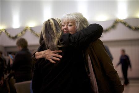 A member of the congregation at New Covenant Community Church embraces Terri Roberts, the mother of Amish school shooter Charles Roberts, after she spoke during the service in Delta, Pennsylvania December 1, 2013. REUTERS/Mark Makela