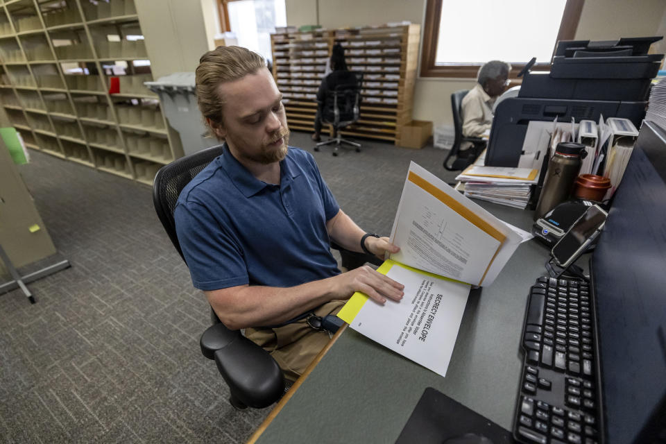 Trey Forrest, Absentee Election Coordinator for the Jefferson County/Birmingham (Ala) Division, prepares absentee ballots for the November election, Tuesday, Sept. 10, 2024, in Birmingham, Ala. (AP Photo/Vasha Hunt)