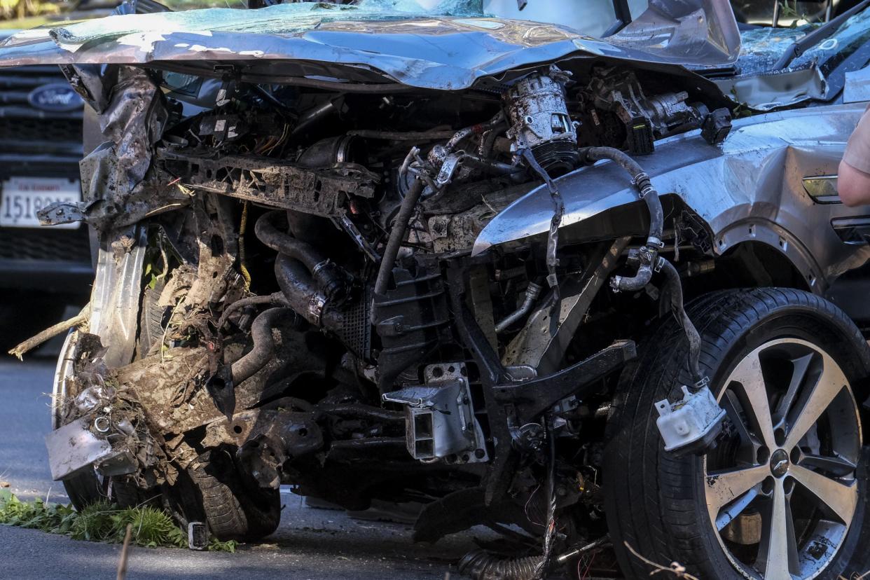 A vehicle rests on its side after a rollover accident involving golfer Tiger Woods along a road in the Rancho Palos Verdes suburb of Los Angeles on Tuesday, Feb. 23, 2021.