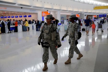 Members of the U.S. Army monitor the departures area at John F. Kennedy international Airport in the Queens borough of New York, U.S., June 29, 2016. REUTERS/Andrew Kelly