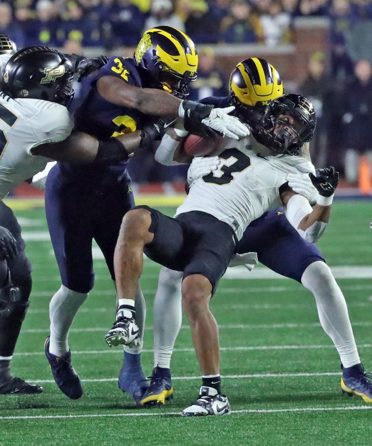 Michigan Wolverines defenders tackle Purdue Boilermakers running back Tyrone Tracy Jr. (3) during the first half at Michigan Stadium, Saturday, Nov. 4, 2023.
