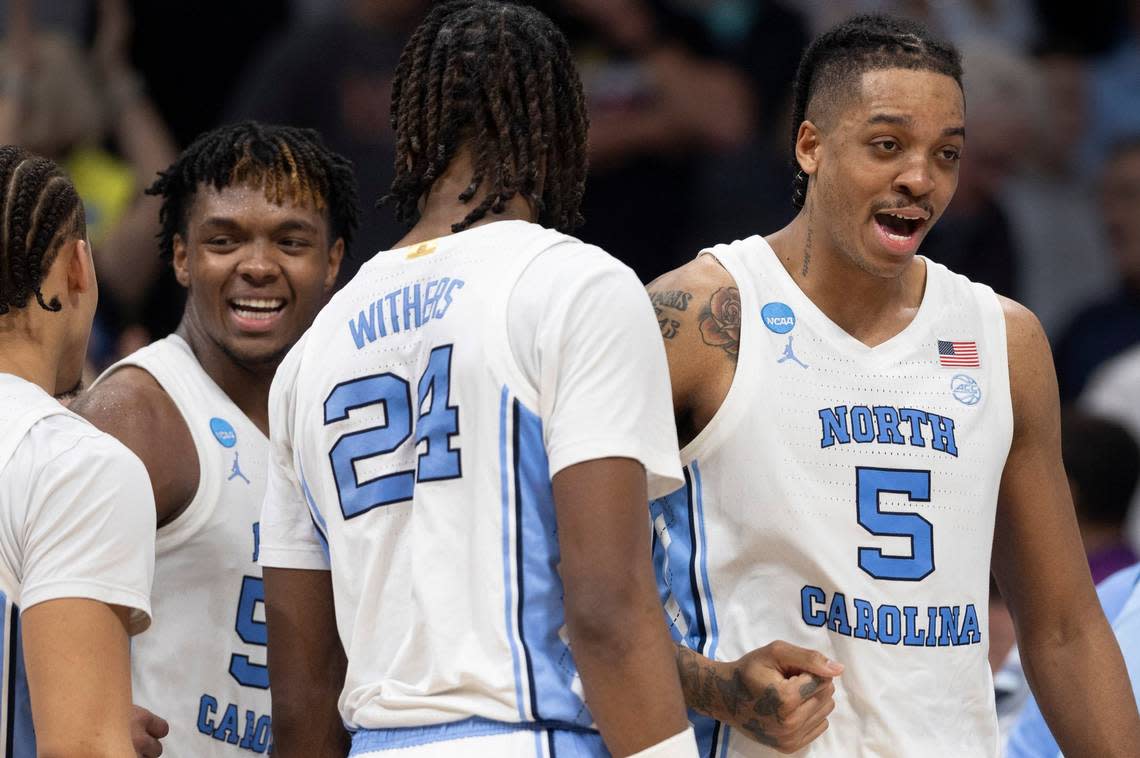 North Carolina’s Seth Trimble (7), Harrison Ingram (55), Jae’Lyn Withers (24) and Armando Bacot (5) celebrate the Tar Heels’ 85-69 victory over Michigan State on Saturday, March 23, 2024 in the second round of the NCAA Tournament at Spectrum Center in Charlotte, N.C.