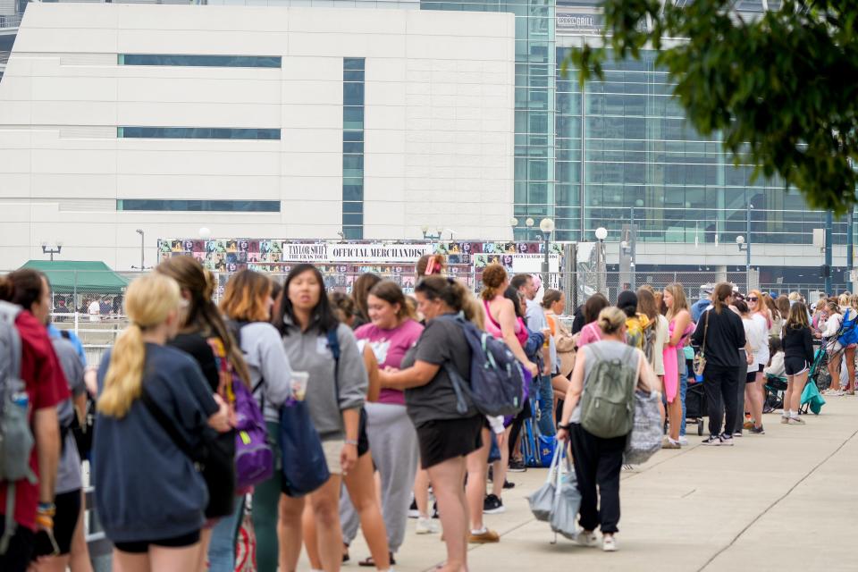 Fans line up along several blocks to get a chance to buy Taylor Swift’s official merchandise from her Eras Tour on Thursday, June 29, 2023, outside Paycor Stadium in Cincinnati.