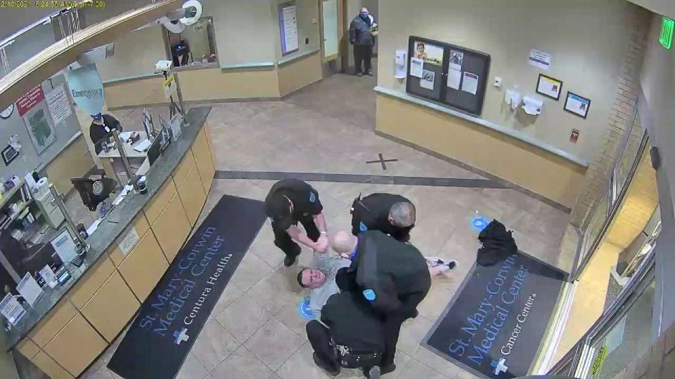 A still frame from a security video at St. Mary Corwin Hospital on Feb. 10, 2021, shows security guards piling on top of Mathew Jones during an altercation in which Jones was killed. The four security guards were initially charged with negligent homicide, but those charges were later dropped. Attorneys for Jones' family filed a wrongful death lawsuit on Wednesday.