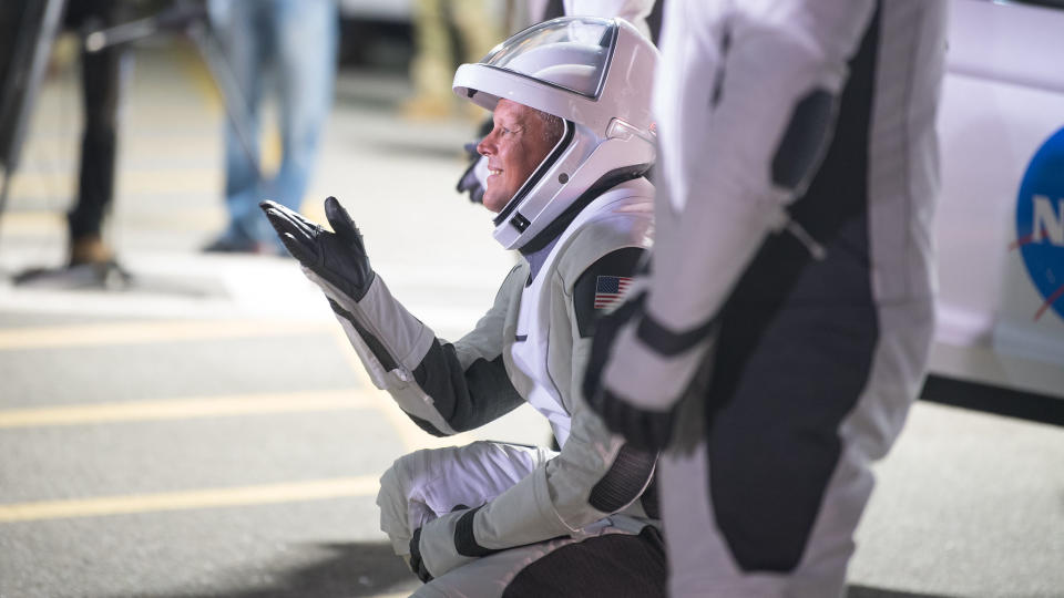 NASA astronaut Robert Hines gestures to family and friends as he and crew mates NASA astronauts Kjell Lindgren, Jessica Watkins, and ESA (European Space Agency) astronaut Samantha Cristoforetti, wearing SpaceX spacesuits, depart the Neil A. Armstrong Operations and Checkout Building for Launch Complex 39A to board the SpaceX Crew Dragon spacecraft for the Crew-4 mission launch, Tuesday, April 26, 2022, at NASA’s Kennedy Space Center in Florida.