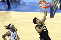 South Carolina's Justin Minaya (10) shoots in front of Kentucky's Isaiah Jackson (23) during the first half of an NCAA college basketball game in Lexington, Ky., Saturday, March 6, 2021. (AP Photo/James Crisp)