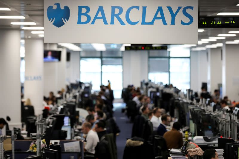 FILE PHOTO: Traders work on the trading floor of Barclays Bank at Canary Wharf in London