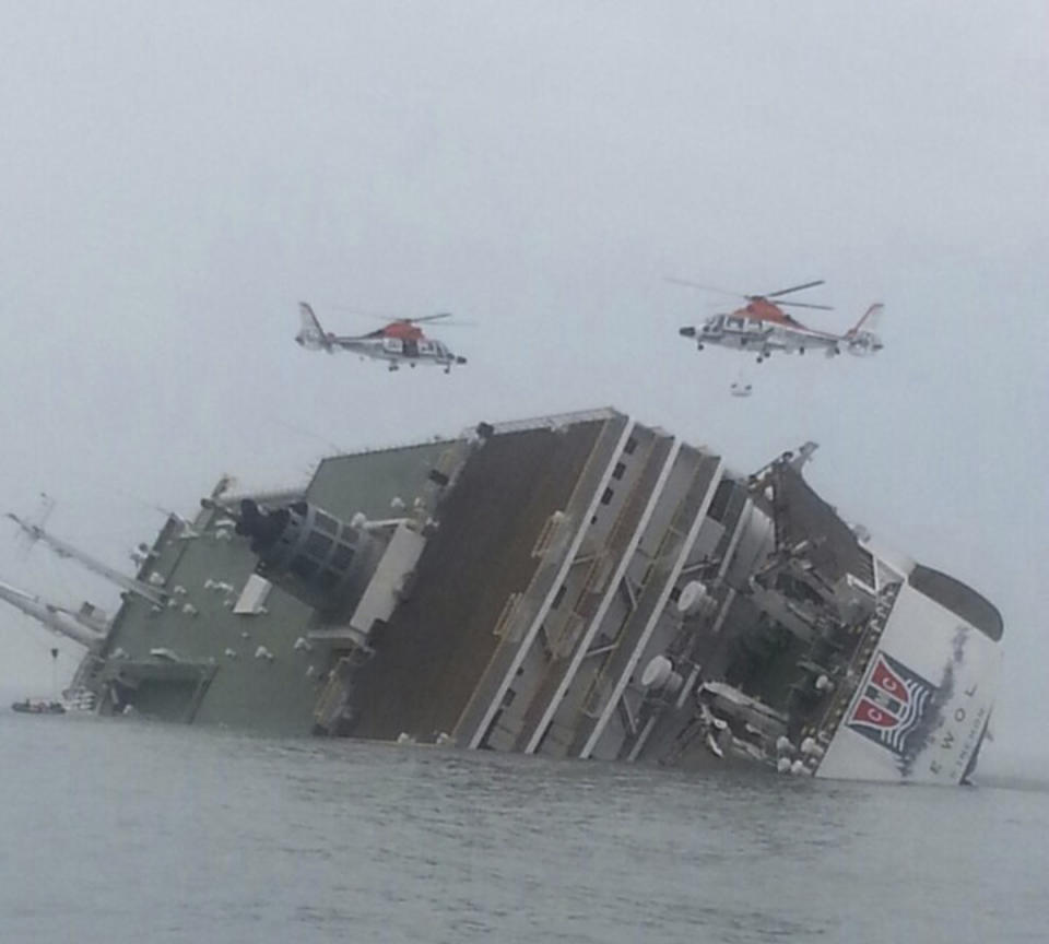 Helicopters are seen above a South Korean passenger ship that has been sinking, in the sea off Jindo