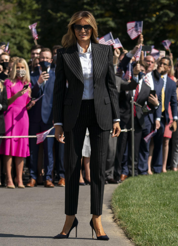 First lady Melania Trump pauses as she and President Donald Trump walk to board Marine One at the White House, Tuesday, Sept. 29, 2020, in Washington, for the short trip to Andrews Air Force Base en route to Cleveland for first debate against Democrat Joe Biden. (AP Photo/Carolyn Kaster)