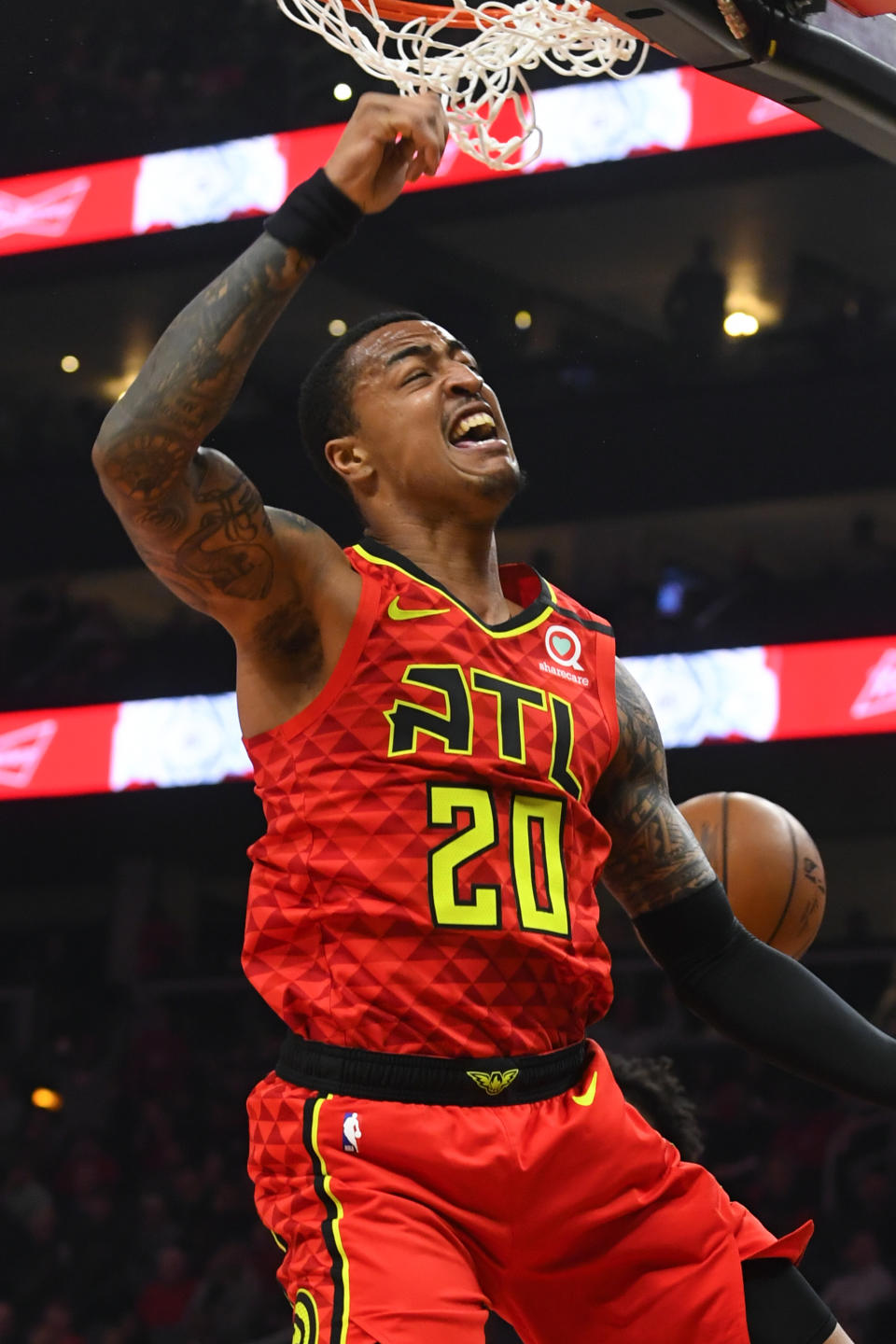 Atlanta Hawks forward John Collins comes down from a dunk during the first half of an NBA basketball game against the Houston Rockets, Wednesday, Jan. 8, 2020, in Atlanta. (AP Photo/John Amis)