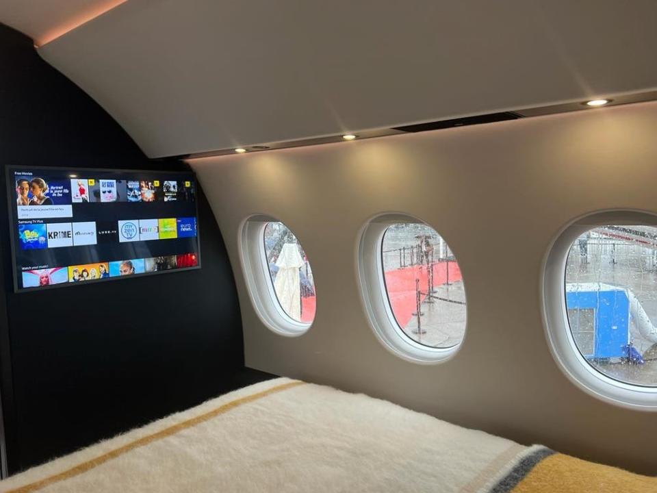 A television at the foot of the bed onboard a Falcon 10X