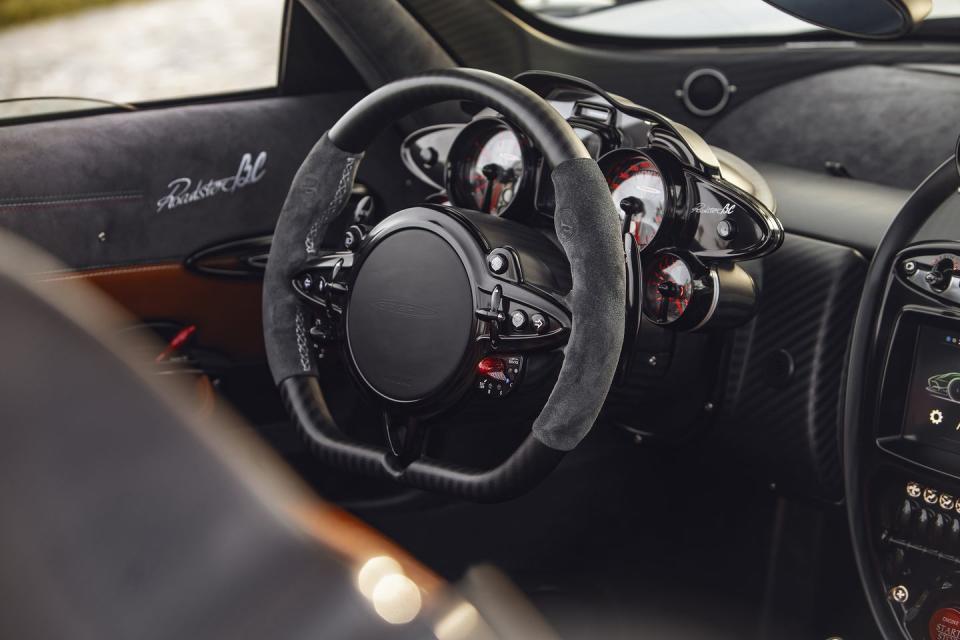 <p><a href="https://www.caranddriver.com/pagani/huayra" rel="nofollow noopener" target="_blank" data-ylk="slk:The Huayra's;elm:context_link;itc:0;sec:content-canvas" class="link ">The Huayra's</a> steering wheel is a bit more understated, but still painfully pretty. The switches each look like they took 100 hours to make, while the wide, flat airbag section seems to work perfectly with the rest of the design.</p>