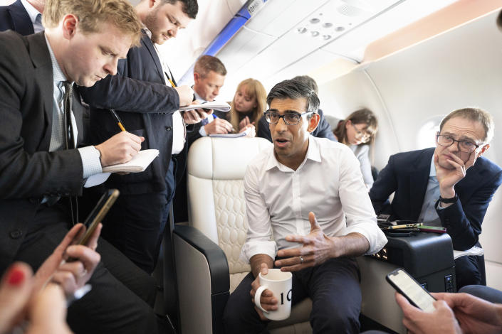 British Prime Minister Rishi Sunak holds a huddle with political journalists on board a government plane Wednesday May 17, 2023 as he heads to Japan to attend the G7 summit in Hiroshima. (Stefan Rousseau, Pool via AP)