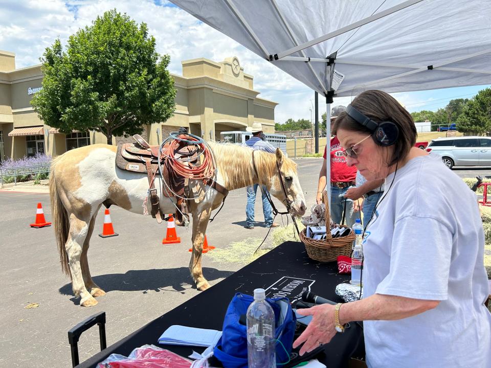 Morgan Tanner with The Eagle 100.9 Radio station and the Labriers' horse are seen at the 60 Years of Wolflin Square event held Friday.