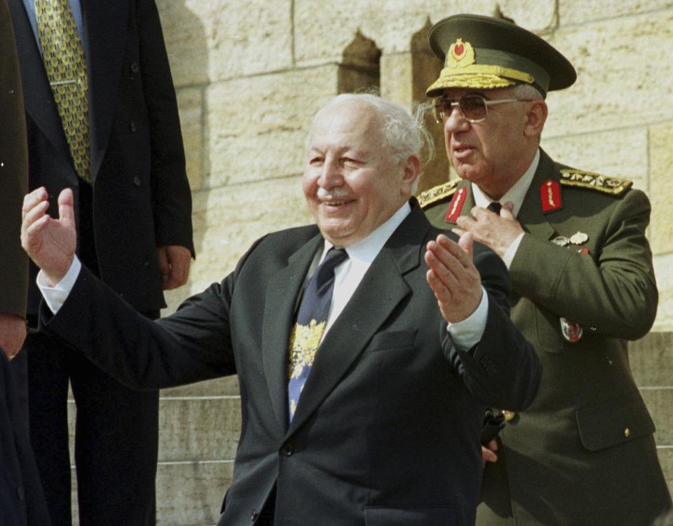 FILE - Turkish then-Prime Minister Necmettin Erbakan greets generals after laying a wreath at the mausoleum of Turkey's founder Kemal Ataturk in Ankara on Monday, May 26, 1997. General Ismail Hakki Karadayi, Turkish then-Chief of Staff, is behind Erbakan. Turkish President Recep Tayyip Erdogan on Friday, May 17, 2024, pardoned seven former top military officers who were sentenced to life terms in prison over the ouster of an Islamic-led government in 1997. The main defendant, former Chief of General Staff Ismail Hakki Karadayi, died in 2020, while the appeals process was still continuing. (AP Photo/Burhan Ozbilici, File)