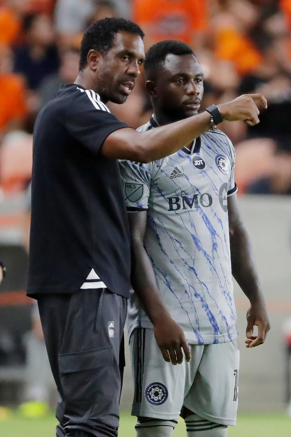 CF Montreal head coach Wilfried Nancy, left, talks with defender Zachary Brault-Guillard, right, who substitutes into an MLS soccer match against the Houston Dynamo during the second half Saturday, Aug. 13, 2022, in Houston. (AP Photo/Michael Wyke)