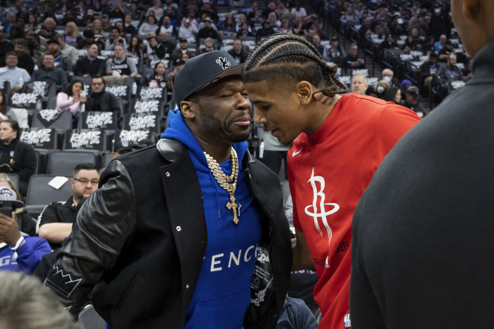 Houston Rockets guard Jalen Green meets rapper 50 Cent before the team's NBA basketball game against the Sacramento Kings in Sacramento, Calif., Wednesday, Jan. 11, 2023. (AP Photo/José Luis Villegas)