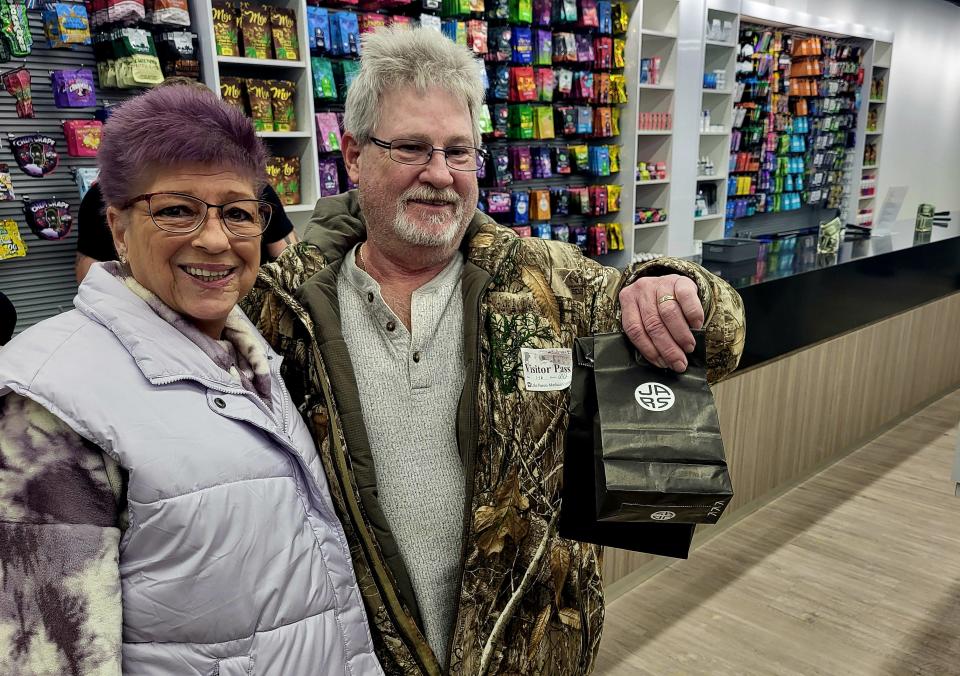 Rick and Donna Harrington, of Port Huron, pause with their purchase from JARS Cannabis on Wednesday, Jan. 17, 2024, after the couple stopped in to check out the new store.