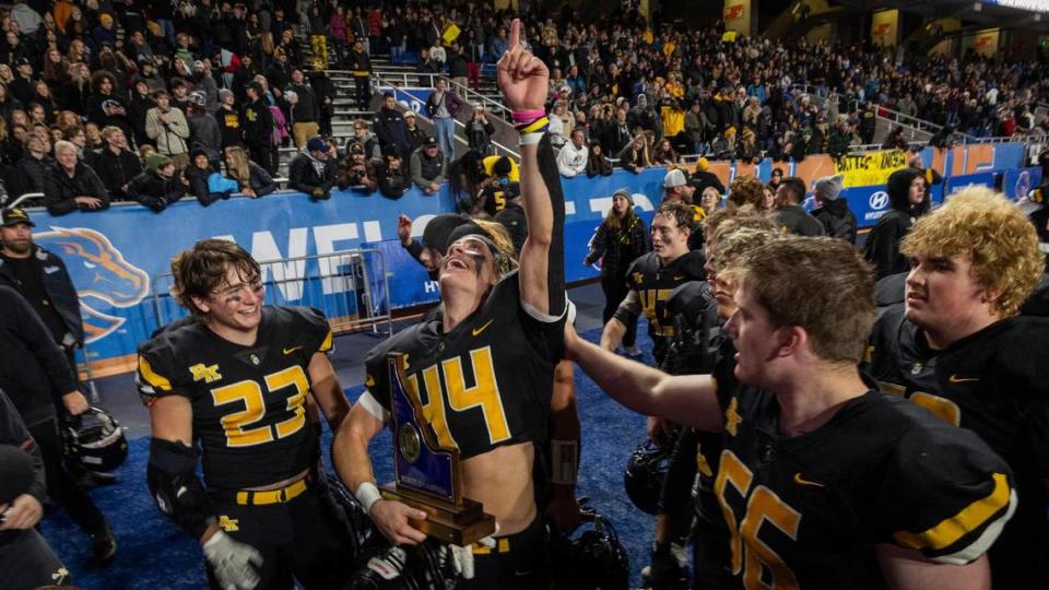 Bishop Kelly senior Peter Minnaert celebrates with the 4A football state championship trophy in November. Minnaert was named the all-class Gatorade player of the year Wednesday.