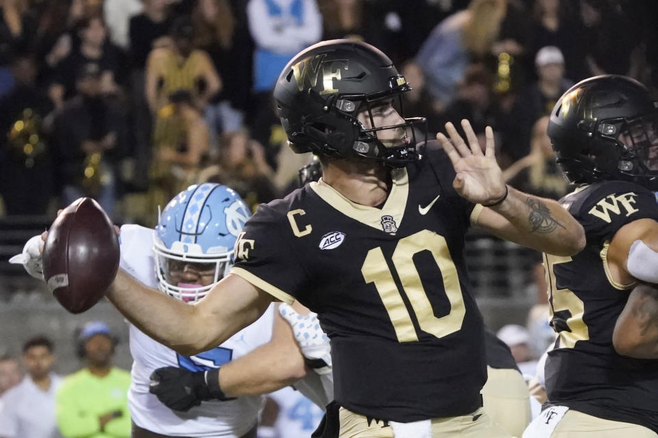 Wake Forest quarterback Sam Hartman (10) looks to pass during the first half of an NCAA college football game in Winston-Salem, N.C., Saturday, Nov. 12, 2022. (AP Photo/Chuck Burton)