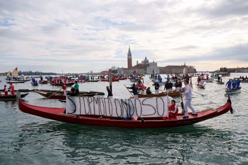 Scores of boats take to the Saint Mark's Basin, as Venetians protest against the damage caused by big ships, in Venice