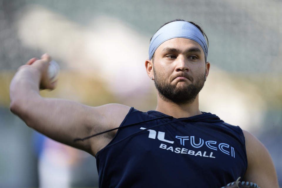 Injured Toronto Blue Jays infielder Bo Bichette joins teammates on the field before the Blue Jays' baseball game against the Colorado Rockies on Saturday, Sept. 2, 2023, in Denver. (AP Photo/David Zalubowski)